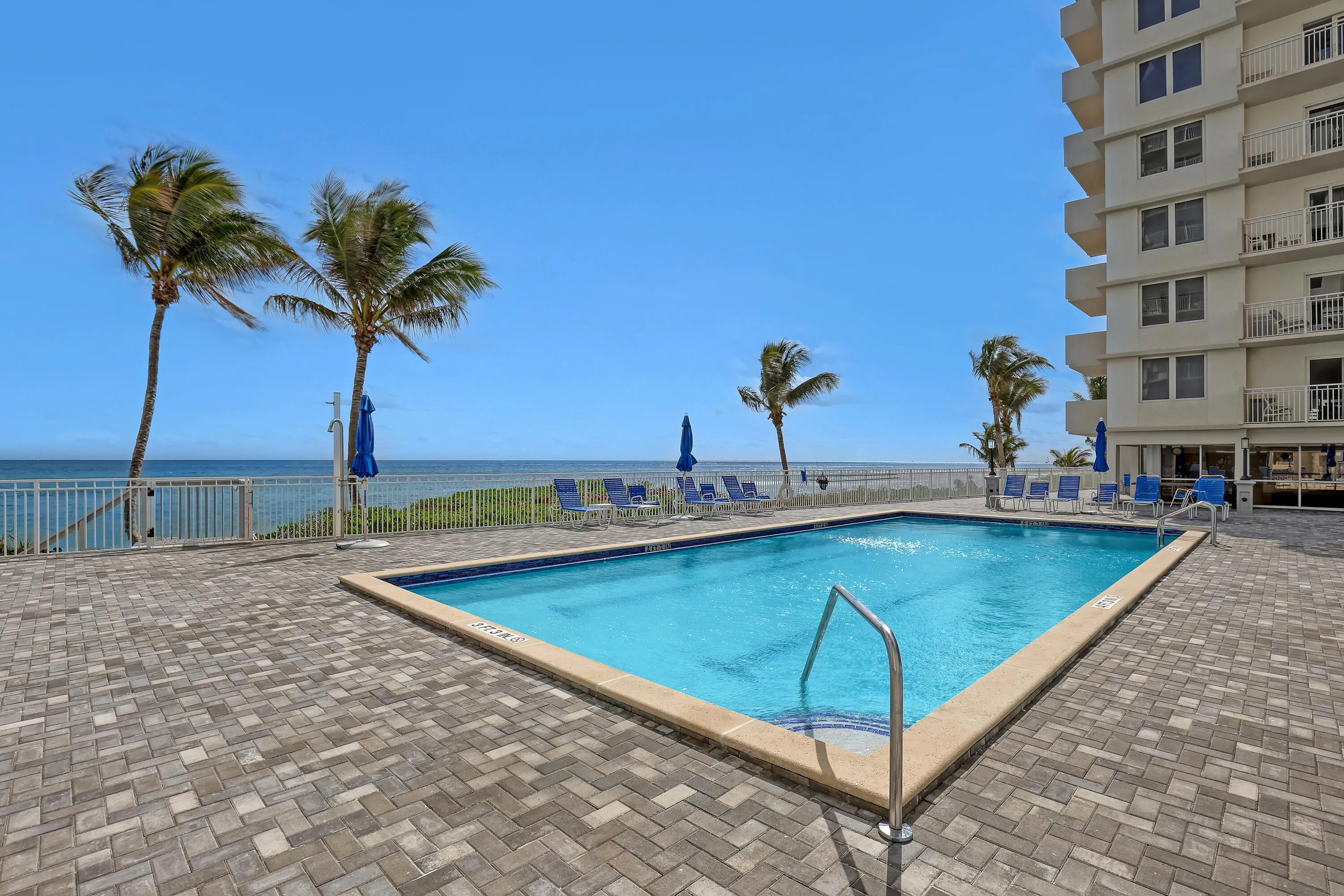 Rectangular swimming pool with integrated steps and a paver-stone surround