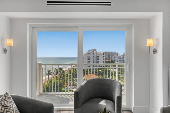 Sliding glass doors opening to a balcony with metal railings