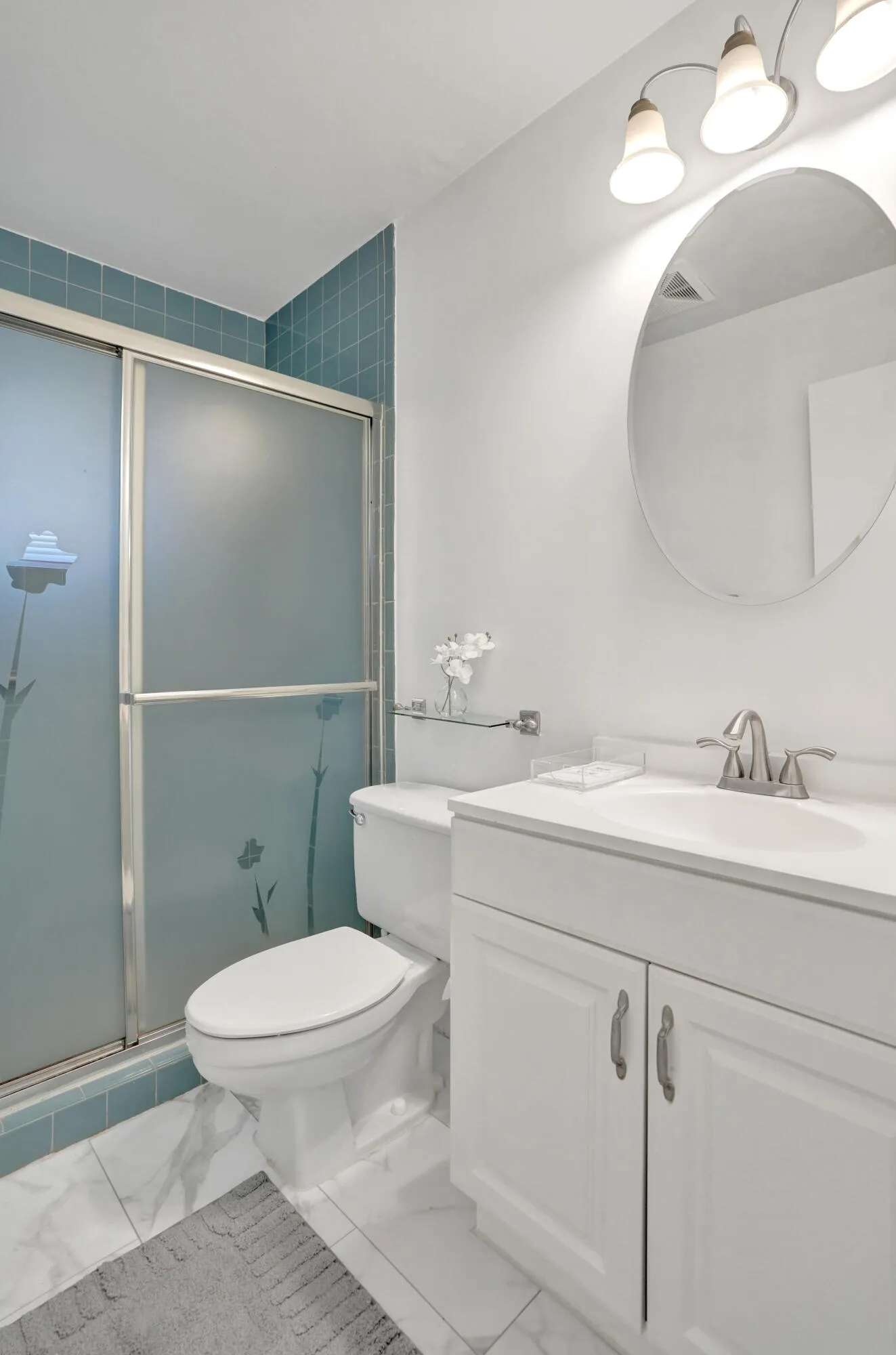 White vanity with brushed nickel hardware, integrated sink, and brushed nickel faucet