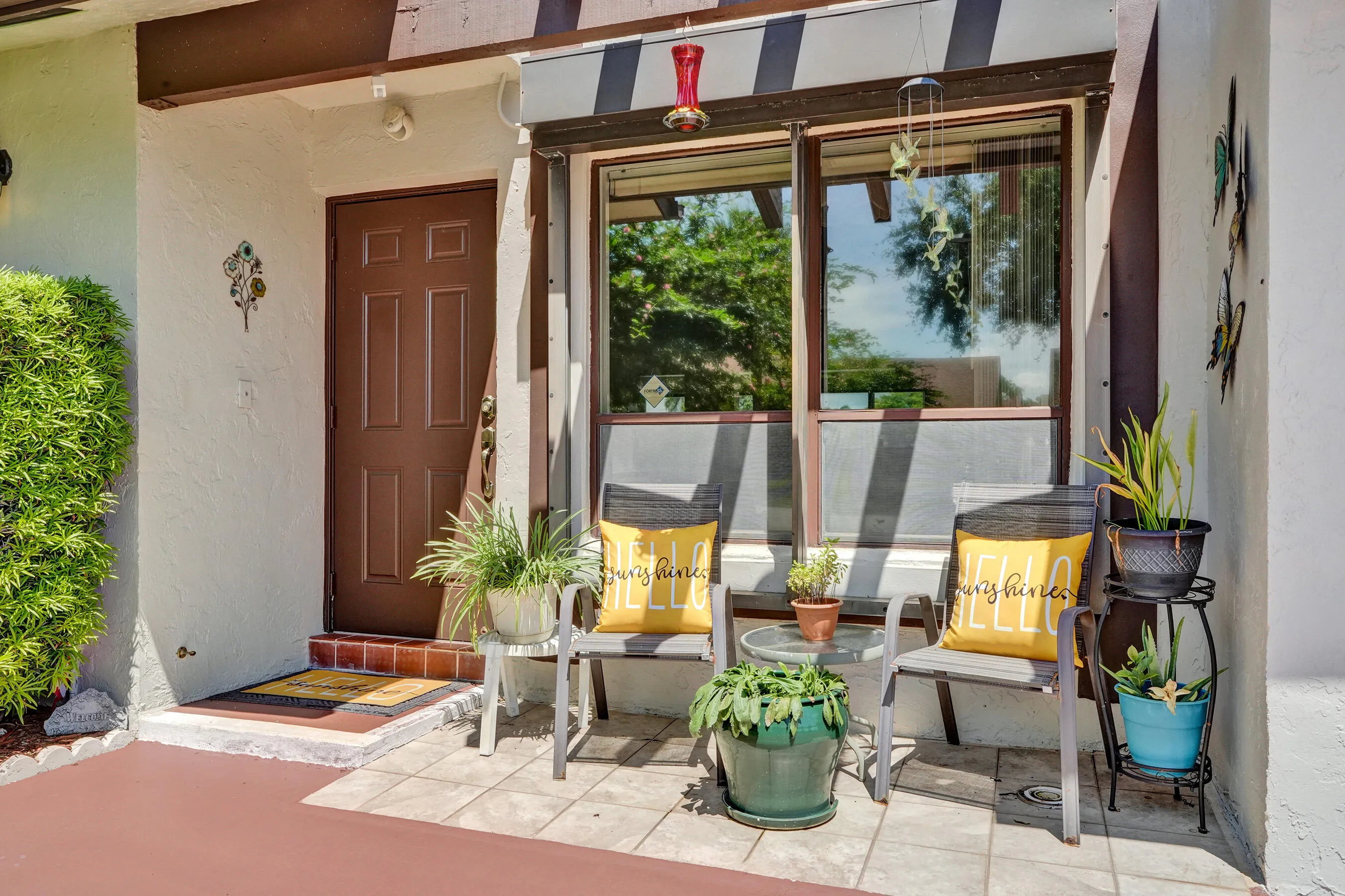 Entry with a paneled door, exterior wall sconce, and tiled porch flooring