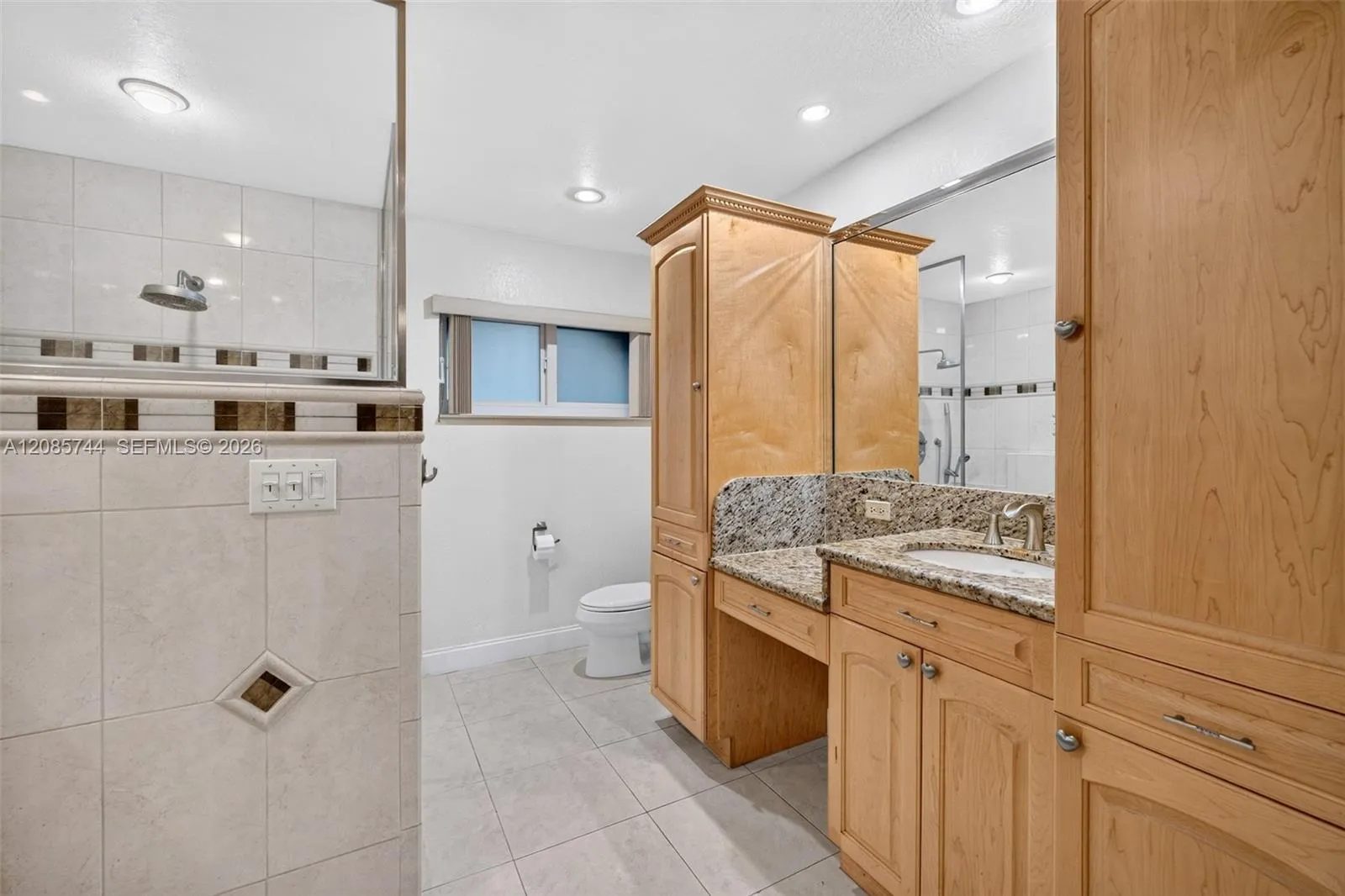 Ensuite bathroom w/ dual vanities w/ vanity area, stall shower & wood cabinets Ensuite bathroom w/ dual vanities w/ vanity area, stall shower & wood cabinets