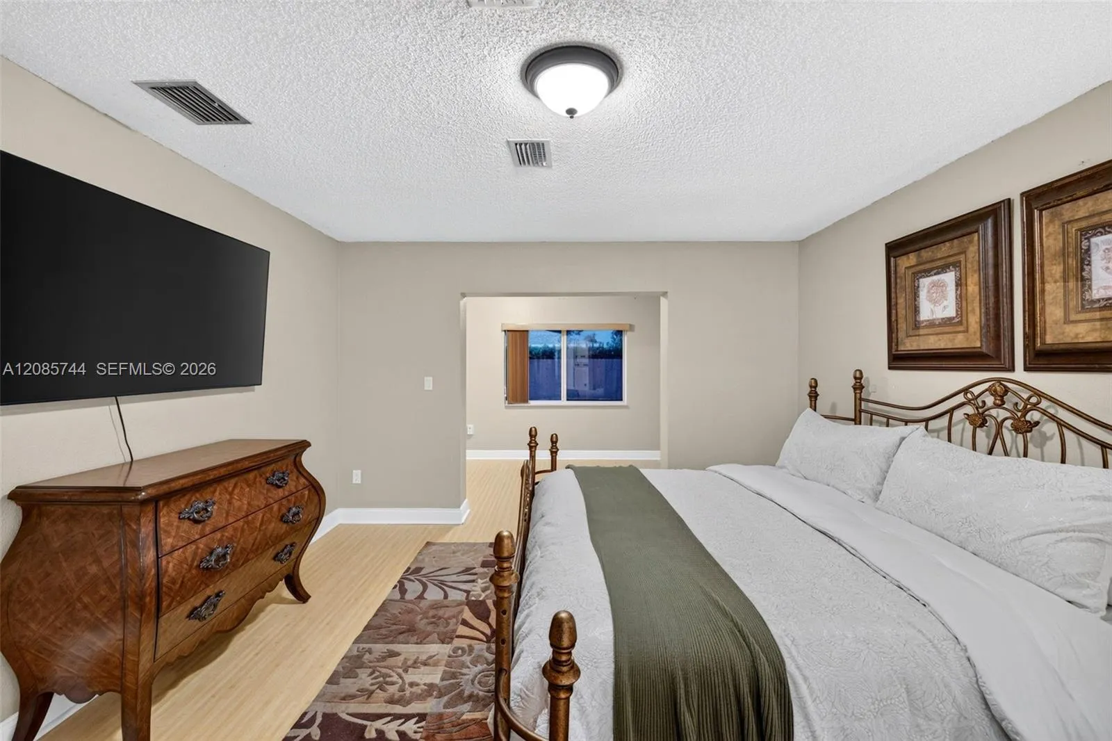 Oversized Primary bedroom w/ sitting area / office / library / nursery / gym add on w/ view to pool area. Laminate floors Oversized Primary bedroom w/ sitting area / office / library / nursery / gym add on w/ view to pool area. Laminate floors