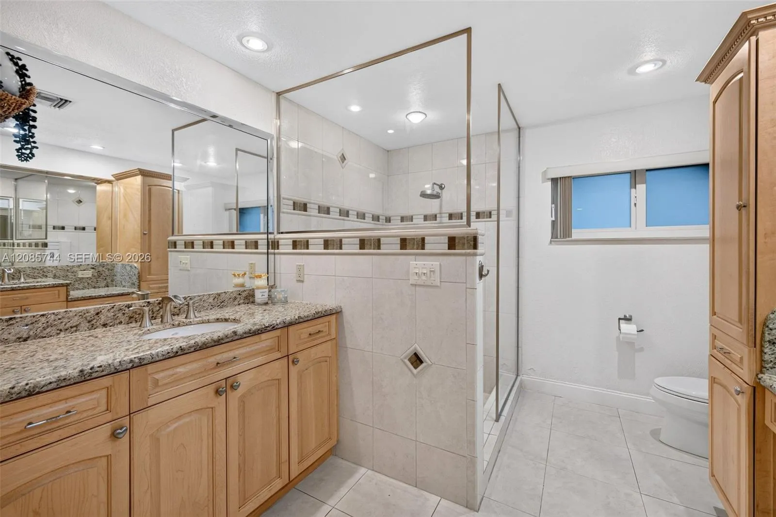 Ensuite bathroom w/ dual vanities w/ vanity area, stall shower & wood cabinets Ensuite bathroom w/ dual vanities w/ vanity area, stall shower & wood cabinets
