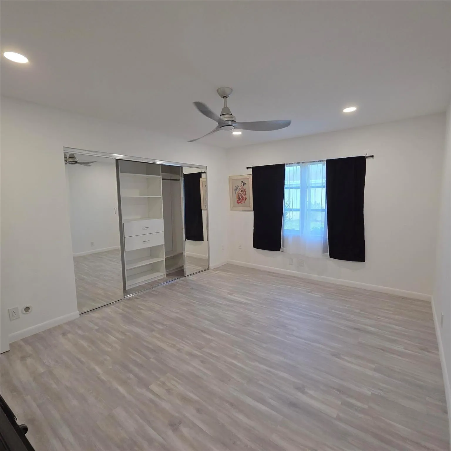 2nd-Guest Bedroom- extra large with fully customized closet, new fan, new floors and large window
