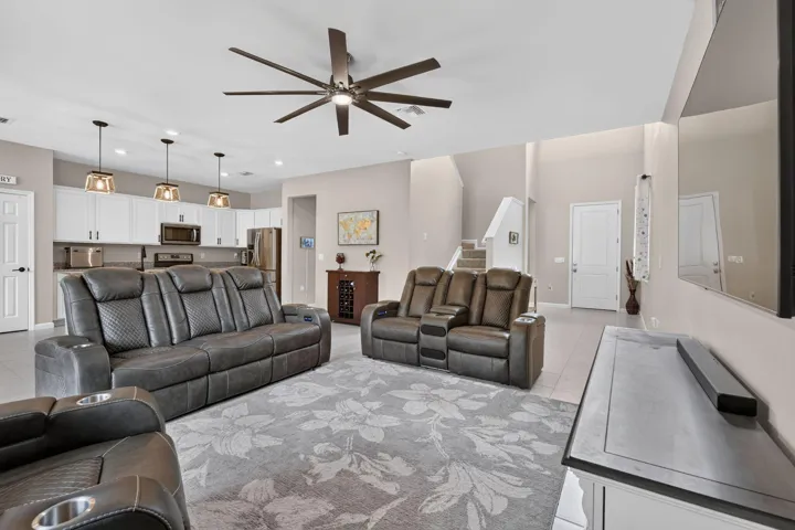 Open concept living space with recessed lighting, a large ceiling fan, and tile flooring