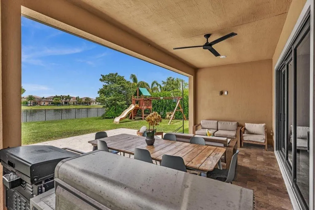 Covered patio featuring a ceiling fan, recessed lighting, and large format tile flooring