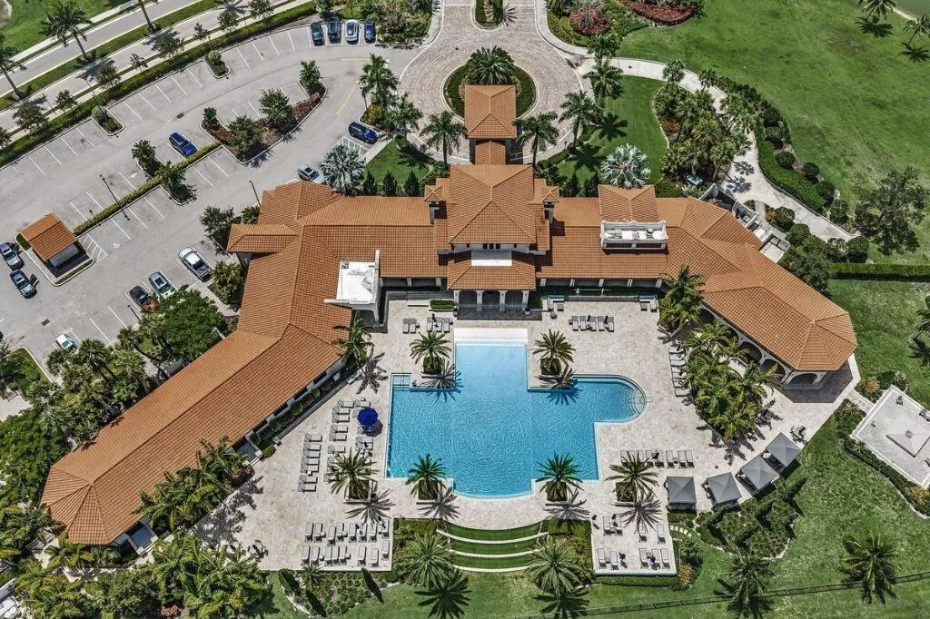 Expansive multi-building complex featuring a large, irregularly shaped swimming pool with integrated spa