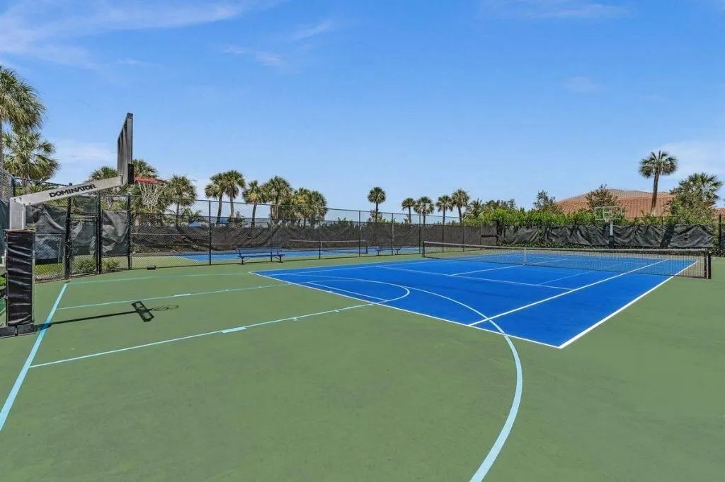 Multi-sport court featuring a blue tennis surface and green basketball court with clear line markings