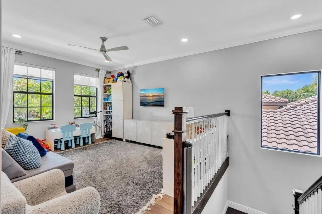 Spacious landing featuring a ceiling fan, recessed lighting, and wood-finish flooring