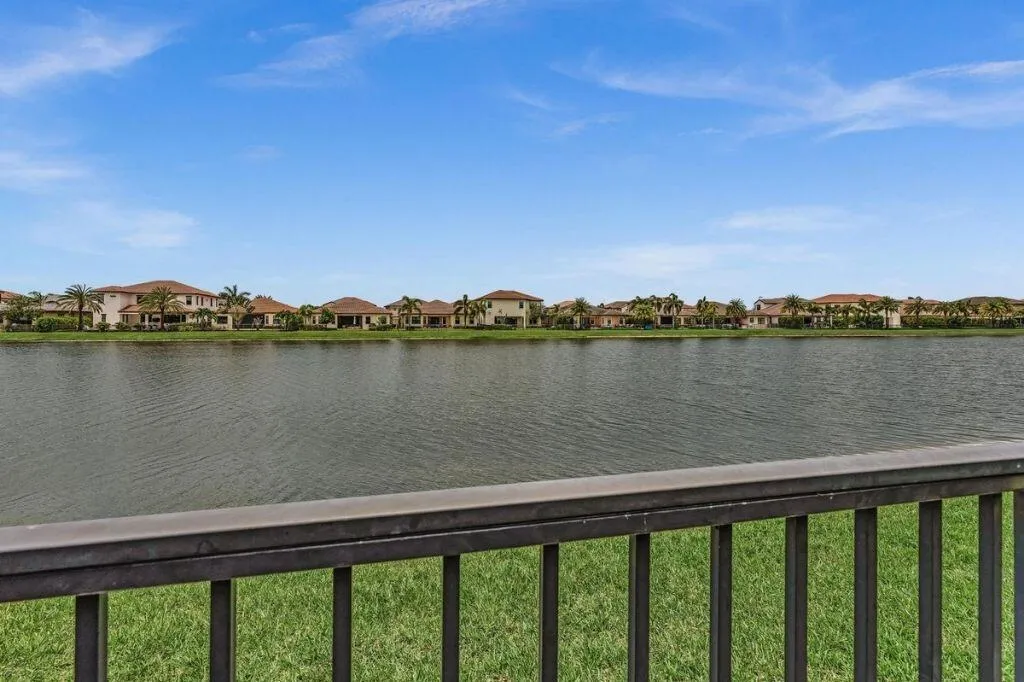 Expansive water body fronting a residential area with mature tropical plantings
