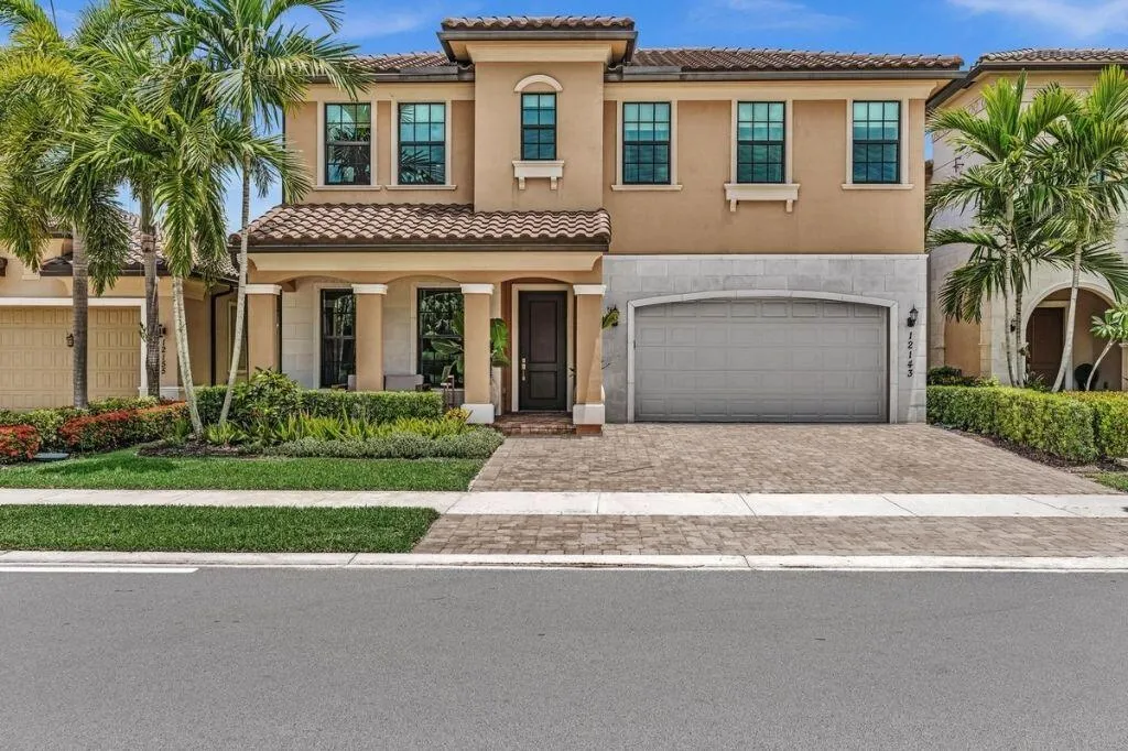 Stucco exterior with a tile roof and decorative stone accents