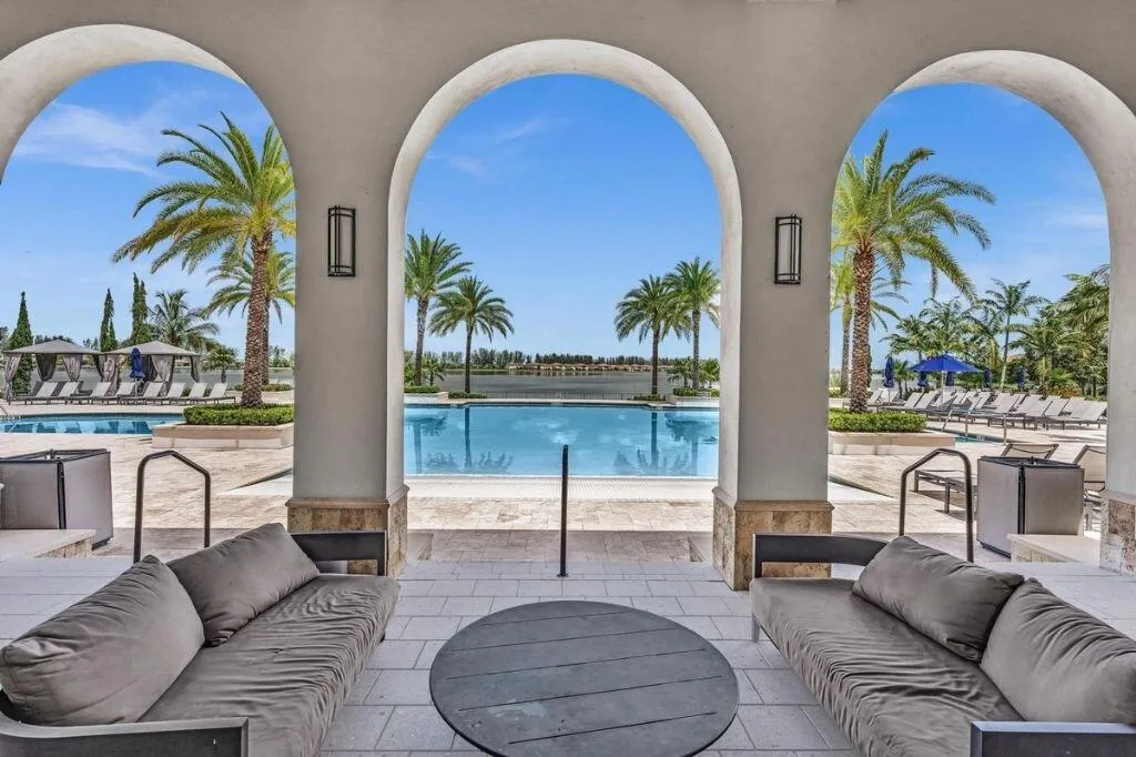 Archway patio featuring an outdoor seating area with direct access to a swimming pool