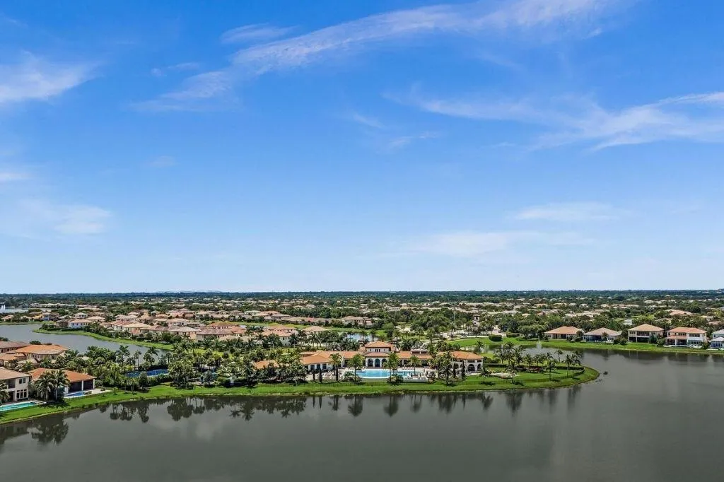 Expansive aerial showcasing a residential community with numerous properties featuring terracotta-style roofing