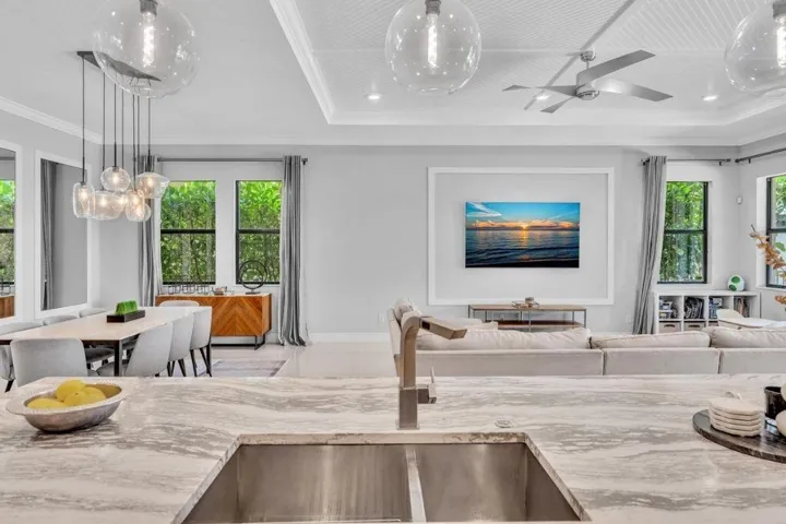 Kitchen island with a stainless steel sink and a modern faucet