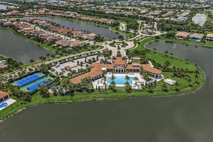 Clubhouse with a central swimming pool, multiple tennis courts, and surrounding residential properties