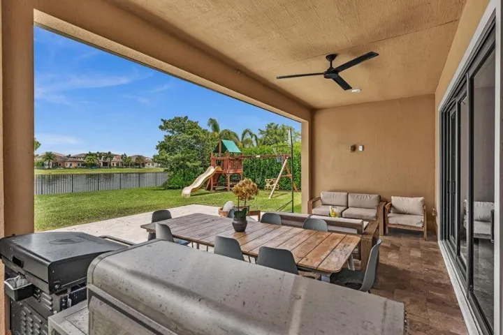 Covered patio featuring a ceiling fan, recessed lighting, and large format tile flooring
