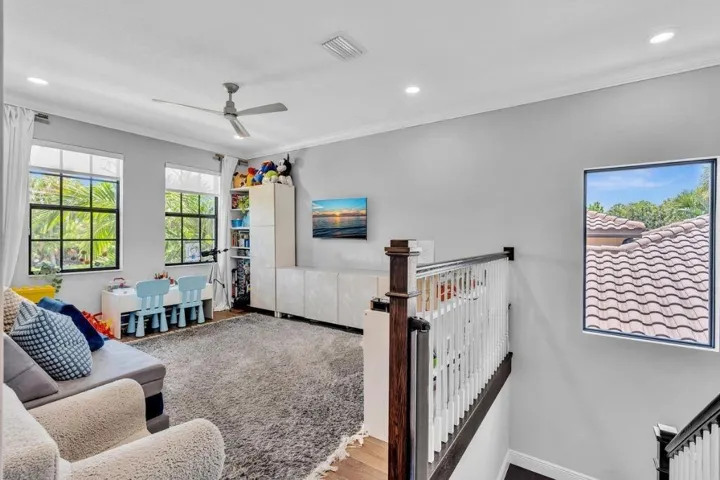 Spacious landing featuring a ceiling fan, recessed lighting, and wood-finish flooring