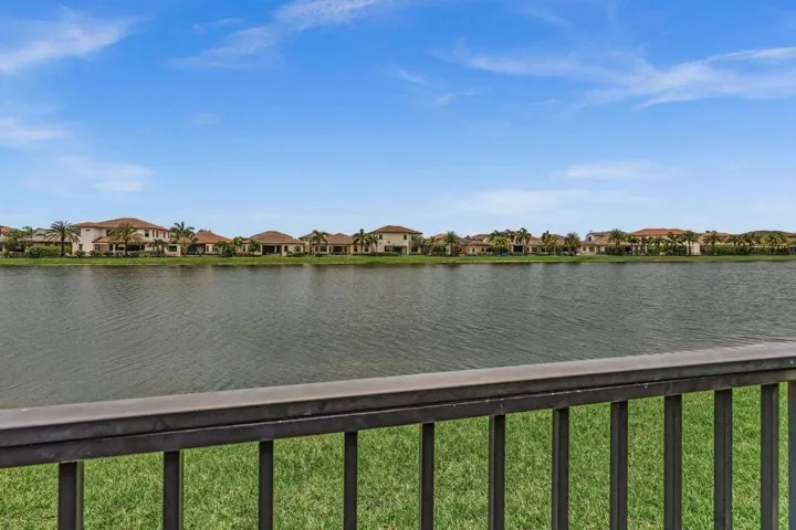 Expansive water body fronting a residential area with mature tropical plantings