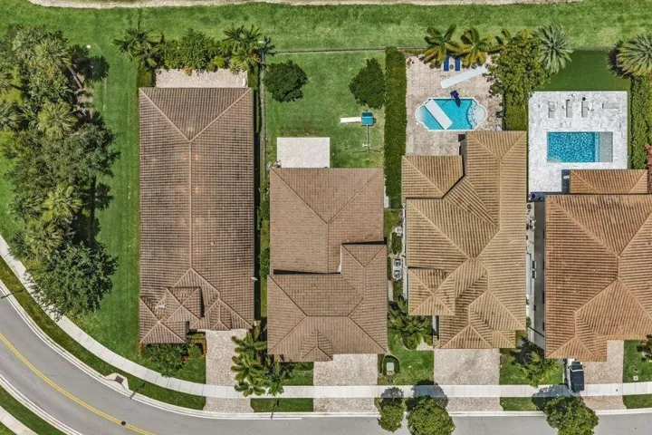 Aerial perspective highlighting multiple residences with terracotta-style tile roofs