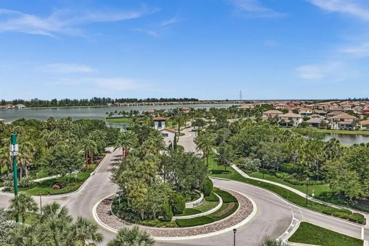 Panoramic water views, lush tropical landscaping, and a grand entrance with a circular drive