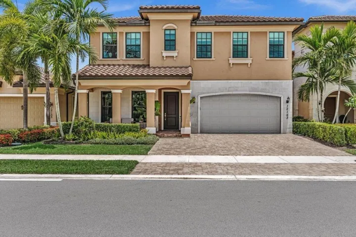 Stucco exterior with a tile roof and decorative stone accents