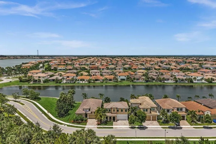 Residential community featuring waterfront properties with tile roofs and mature landscaping