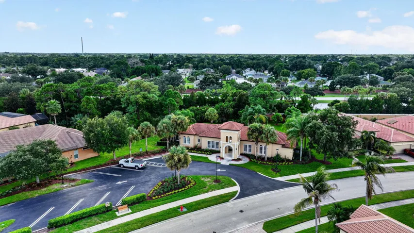 Mediterranean-style Clubhouse with architecture with a tile roof, stucco exterior, and arched entry