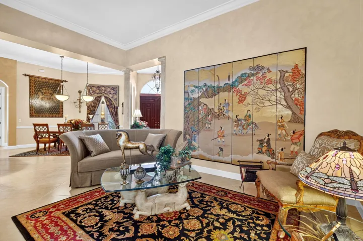 Recessed lighting, crown molding, and neutral wall tones complement the tile flooring throughout the space