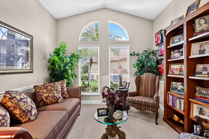 Vaulted ceiling with arched transom windows, twin vertical windows with blinds.