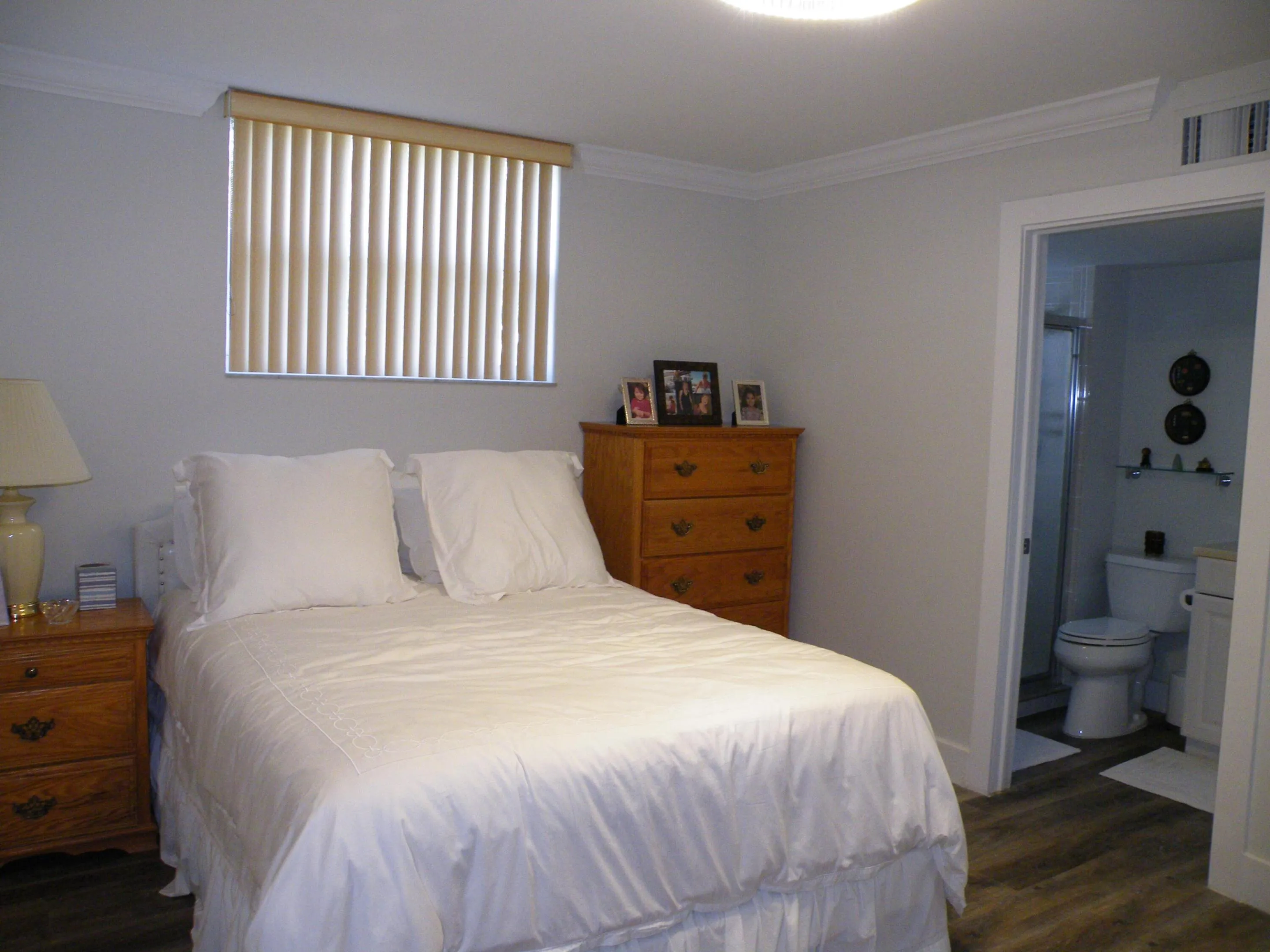 Wood-finish flooring, crown molding, and a neutral color palette