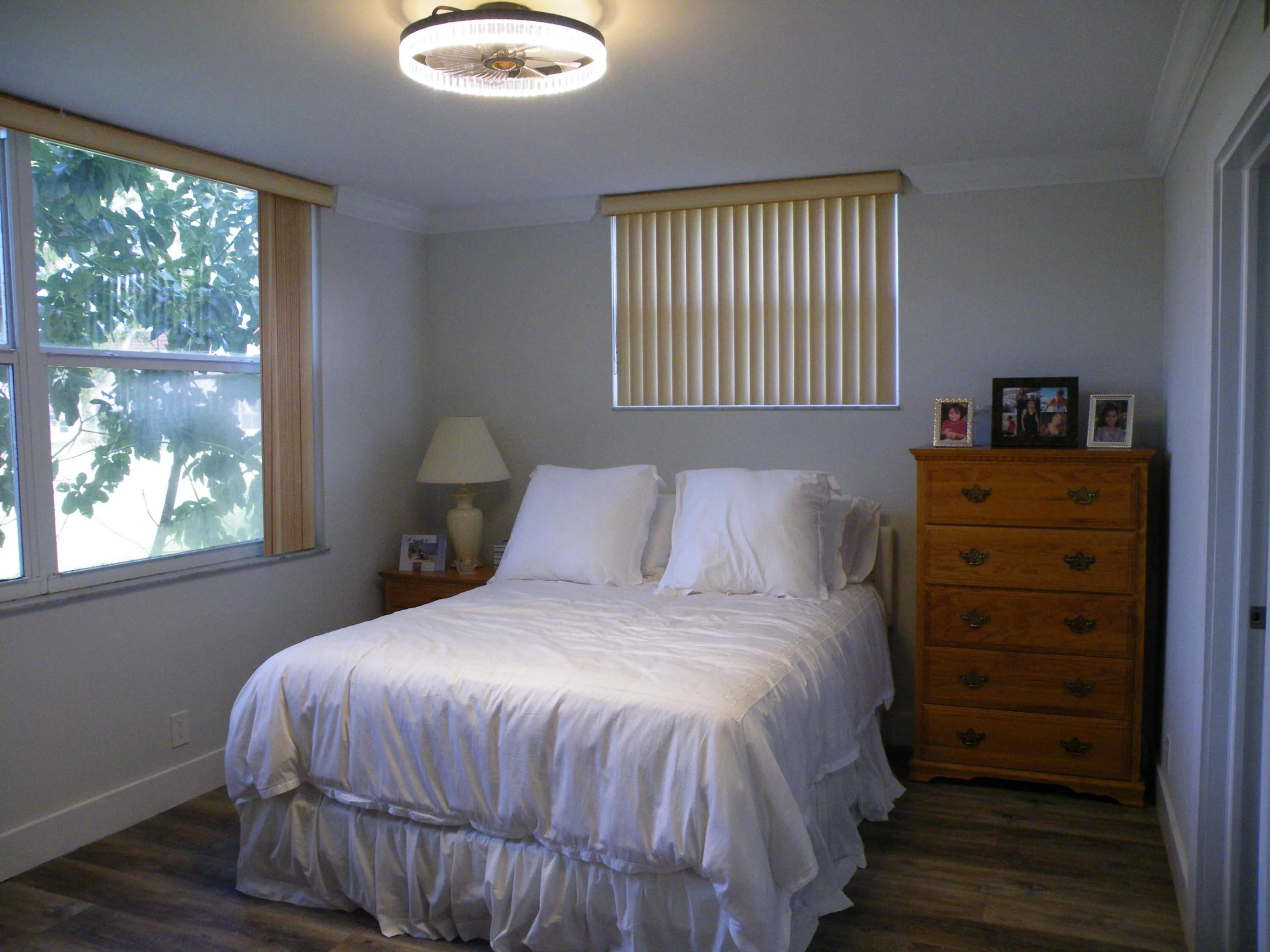 Wood-finish flooring throughout, crown molding details, and a ceiling-mounted light fixture