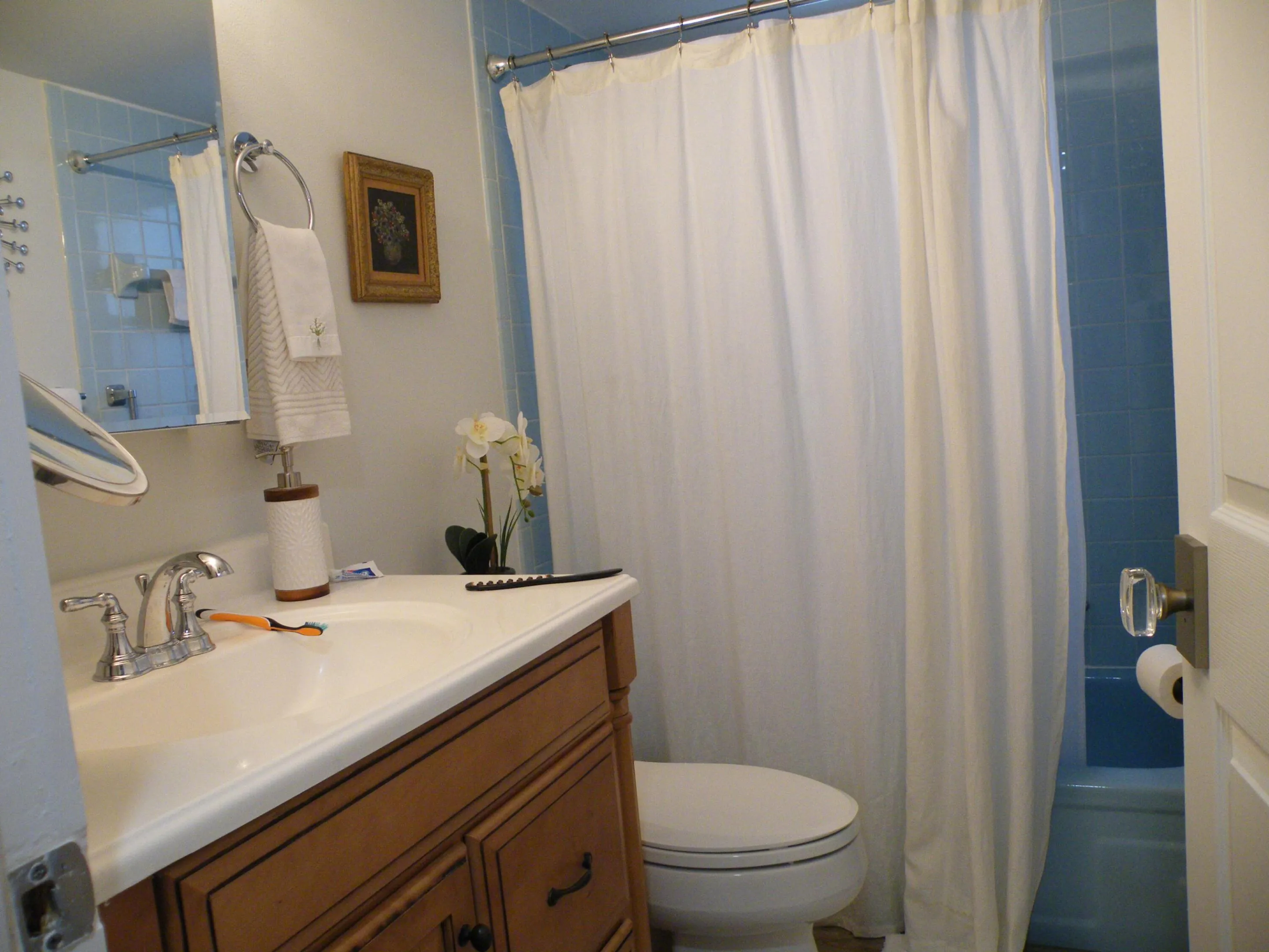 Wood-finish vanity with an integrated sink and chrome faucet