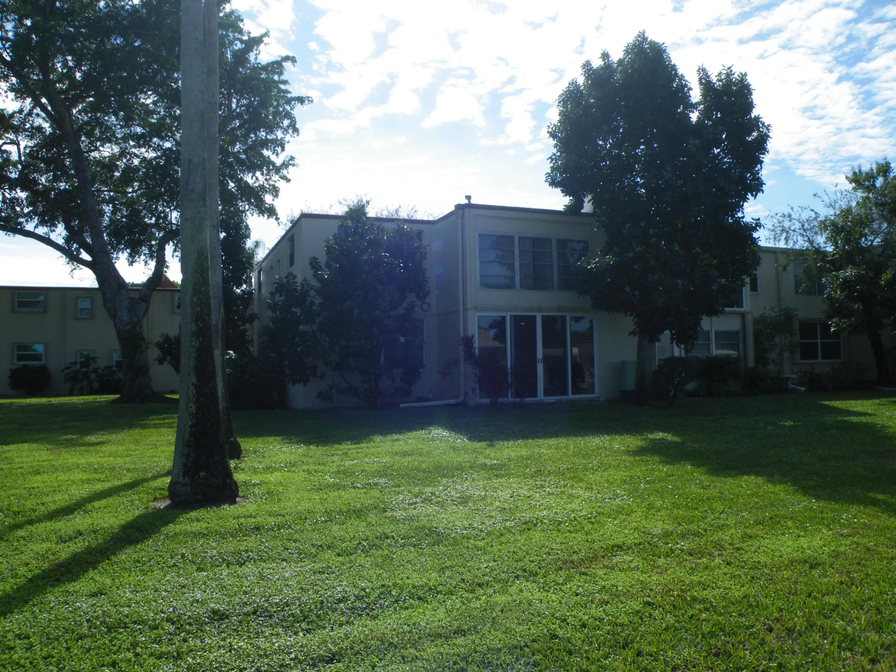 Expansive green lawn with mature trees