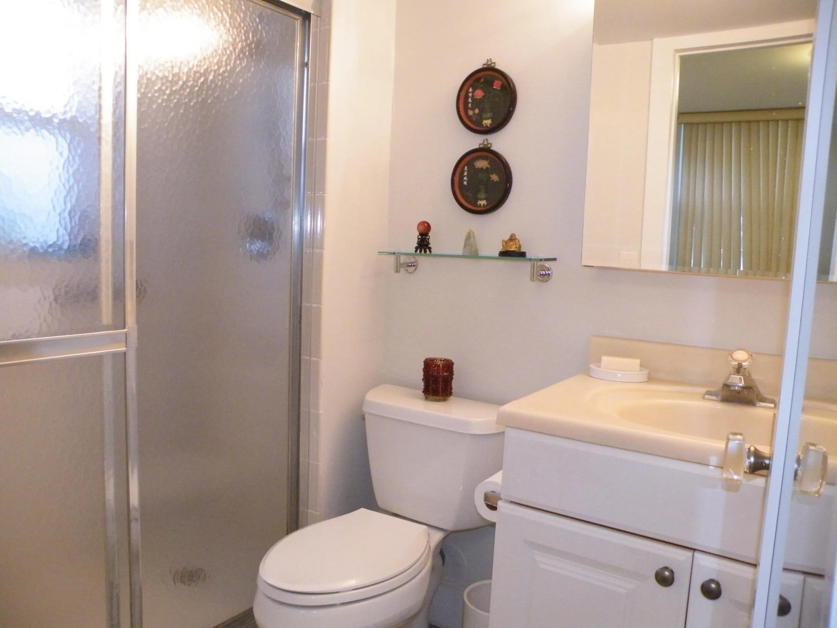 White vanity with integrated sink, chrome faucet, and white cabinetry