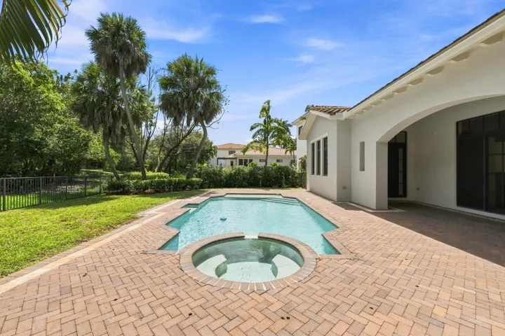 Pool area surrounded by lush landscaping