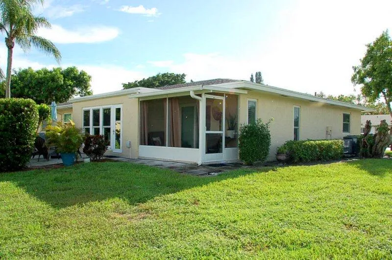 Corner lot - exterior outdoor living space with an open patio and screened lanai