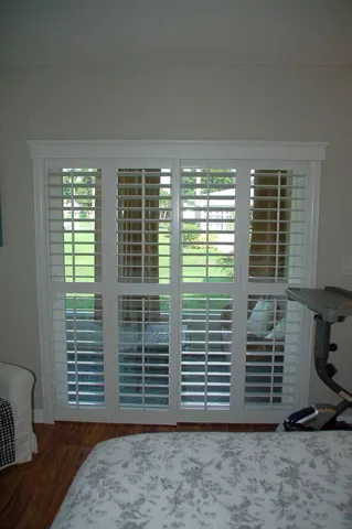 Plantation shutters throughout including the sliding door