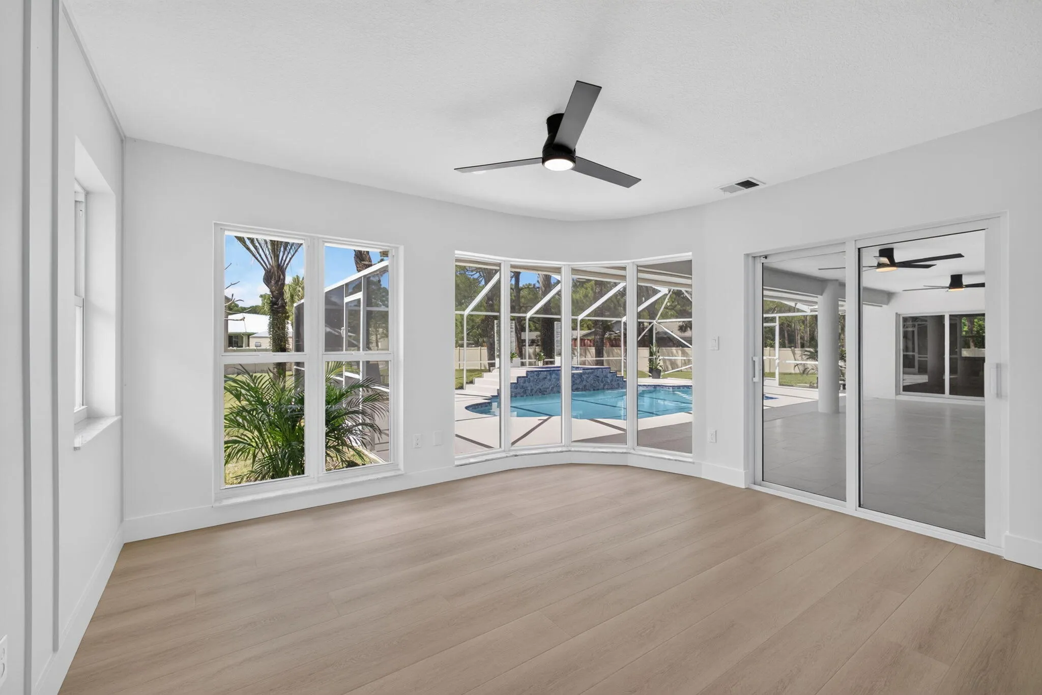 Impact glass sliders, windows overlooking the pool and backyard