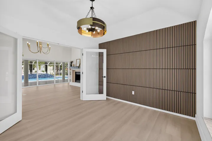 Glass double doors, custom wall detail, chandelier