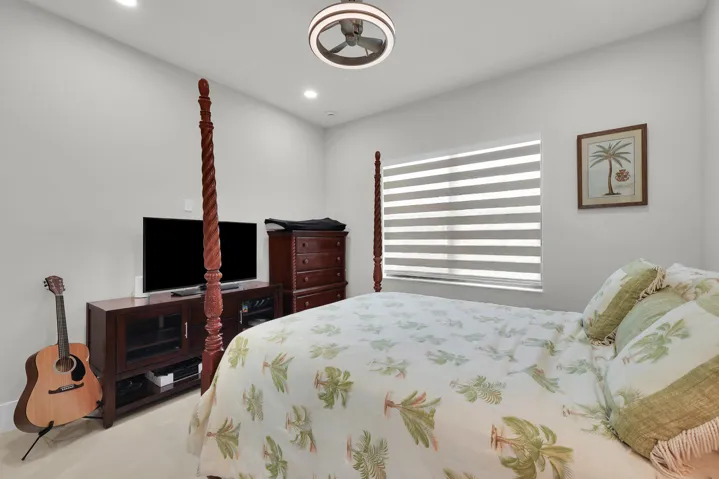 Recessed ceiling lighting, modern ceiling fan, window with horizontal blinds, light-toned wall color, and light-toned flooring