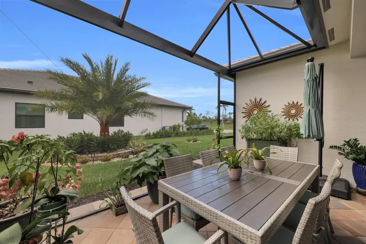 Screened outdoor living area with a paver patio and ample space for dining