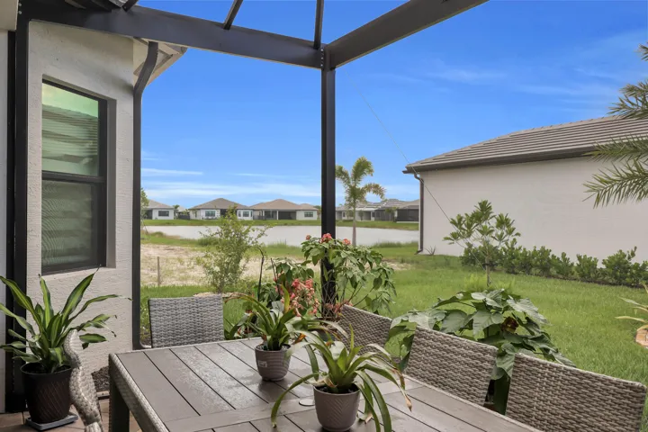 Screened lanai featuring a solid roof structure and exterior stucco finish