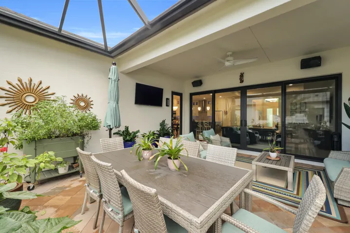Enclosed patio featuring a skylight, ceiling fan, and large sliding glass doors