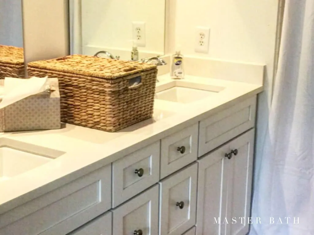Dual vanity with integrated sinks, light-toned countertop, and white shaker-style cabinetry