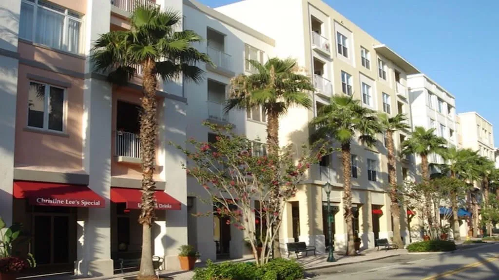 Multi-story building featuring stucco exterior and balconies with white railings