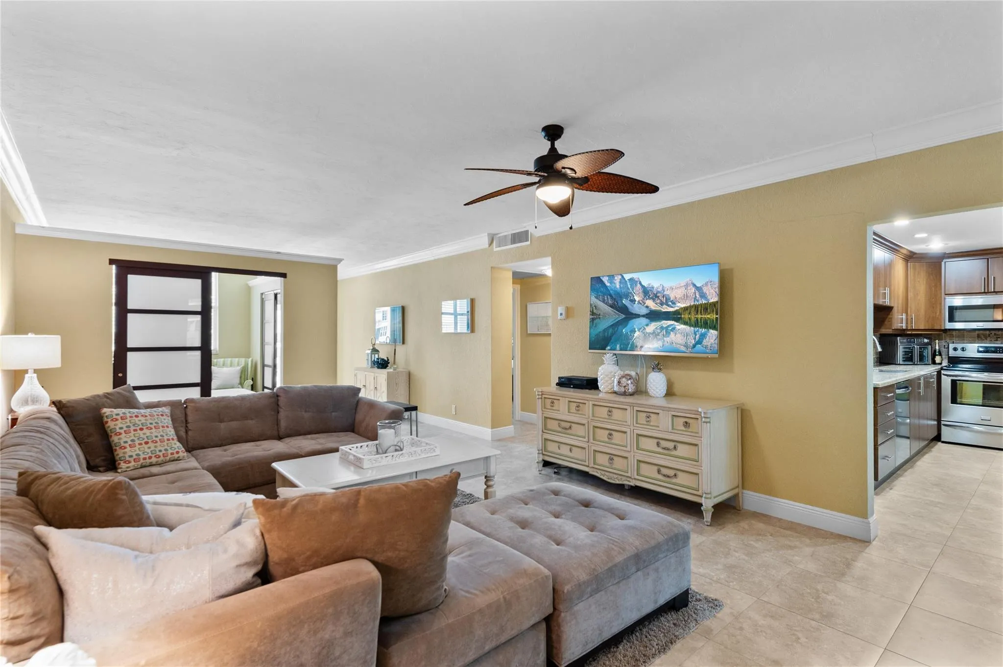 Recessed lighting, crown molding, and a ceiling fan with integrated lighting