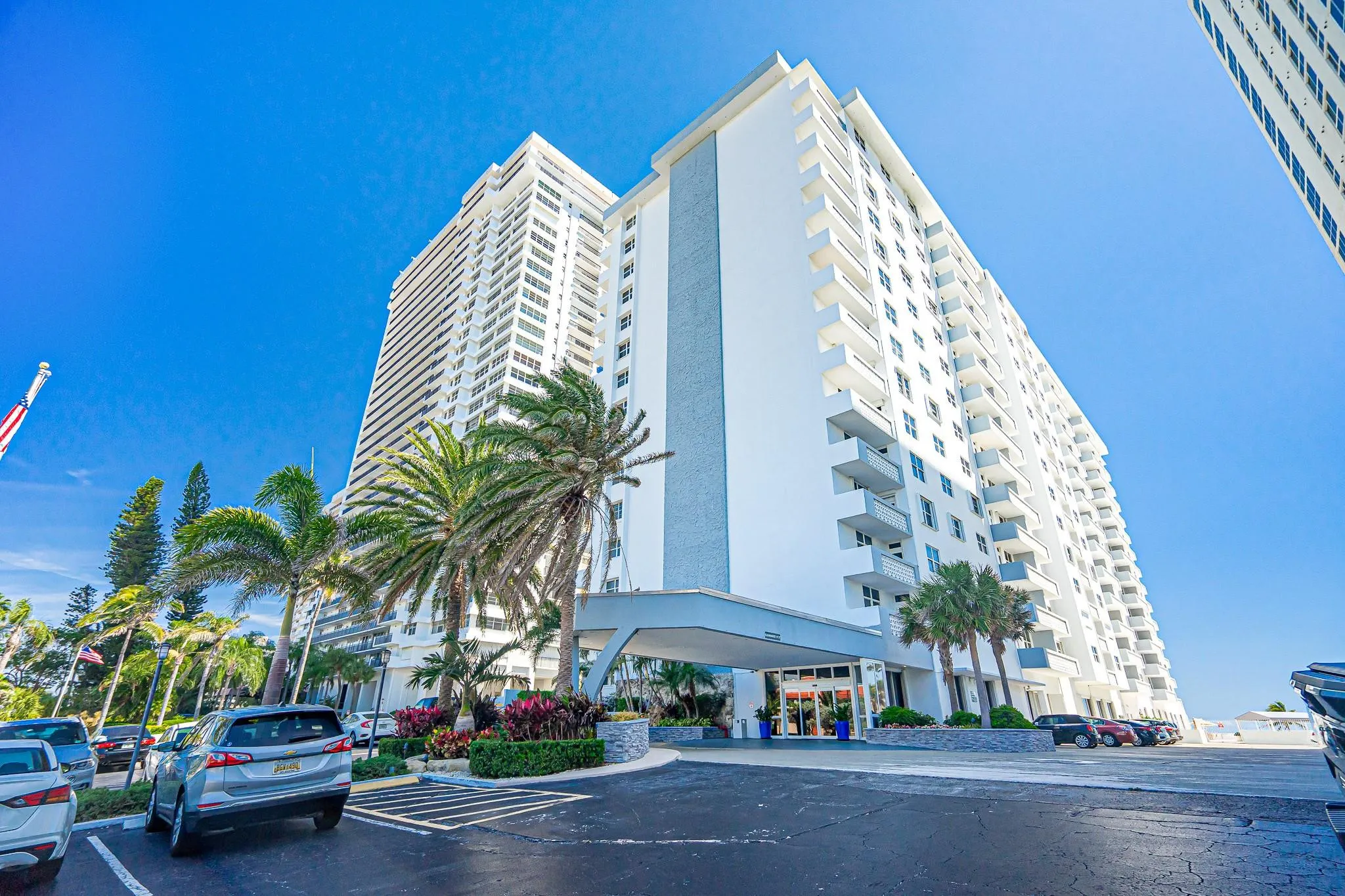 Modern high-rise exterior with multiple balconies and a covered entrance
