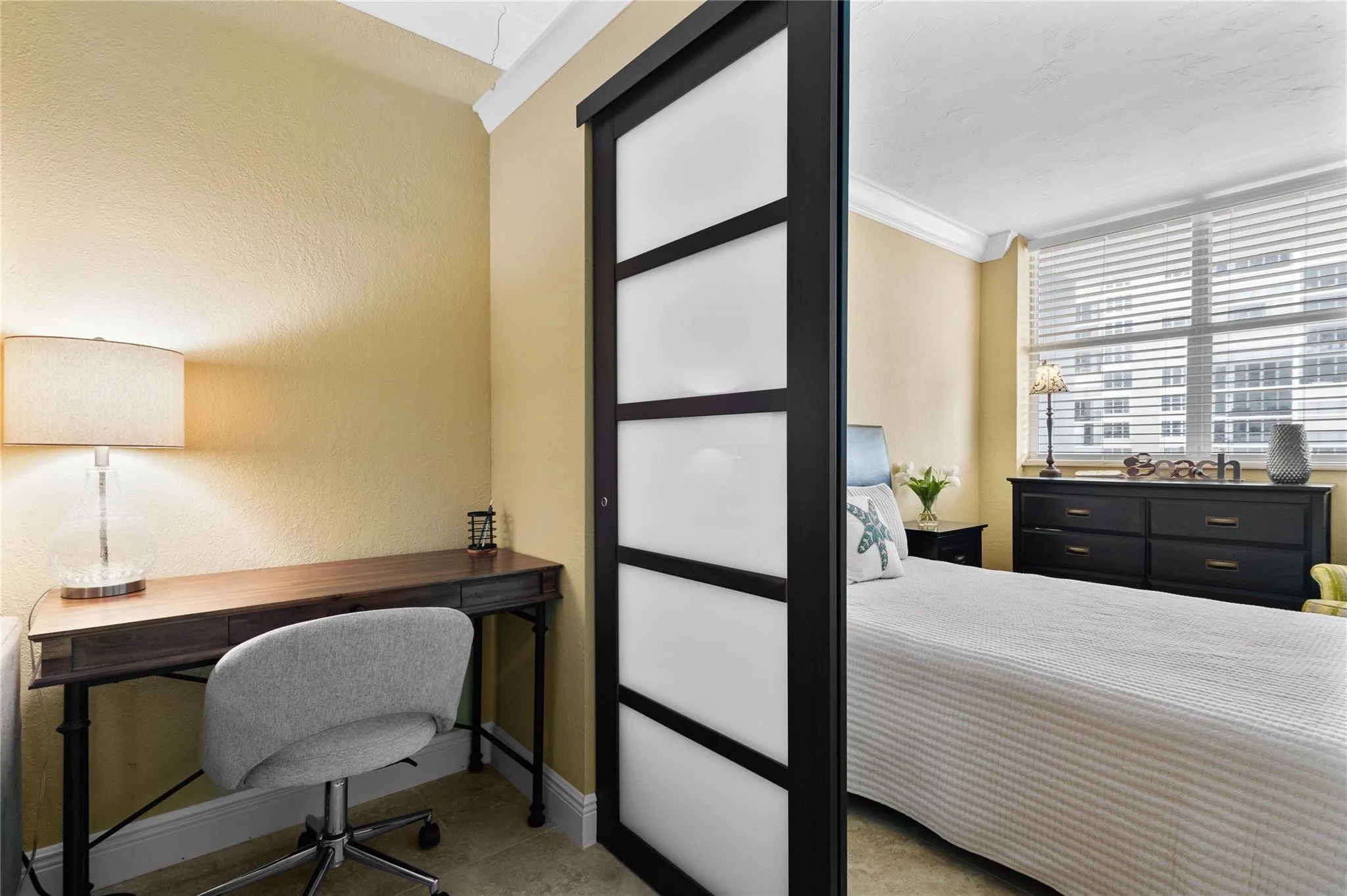 Sliding partition with frosted panels, textured wall finish, and crown molding