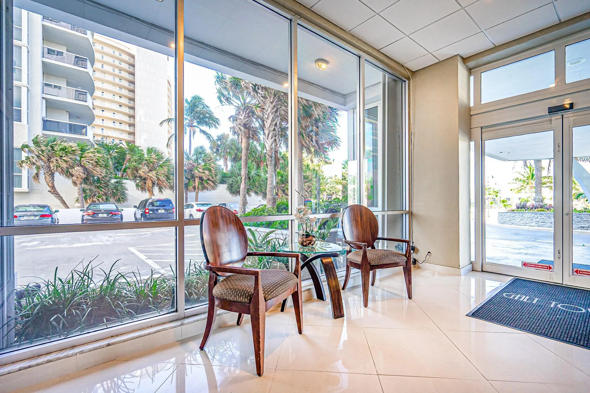 Full-height impact glass windows, polished tile flooring, and automatic entry doors