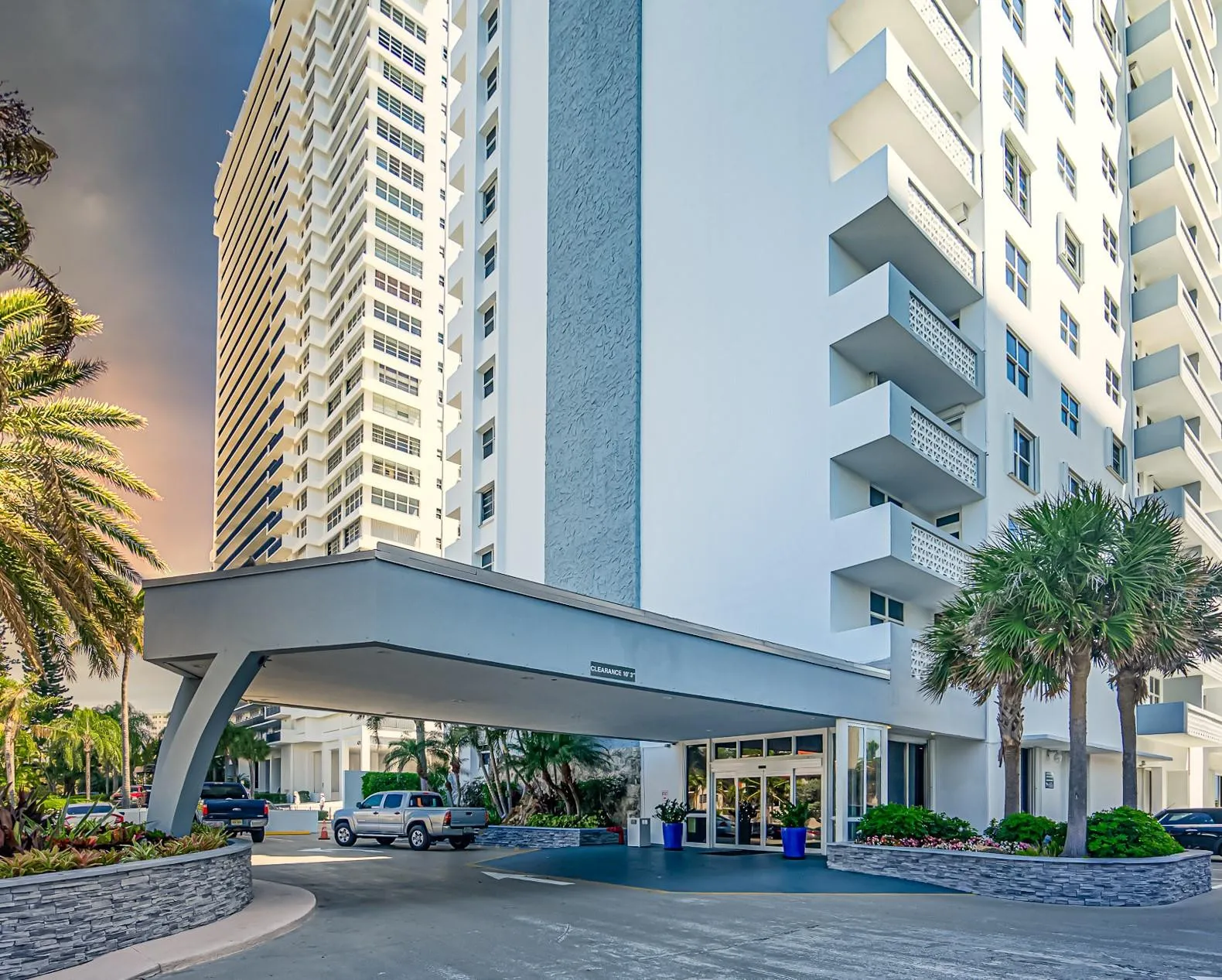 Building exterior with a portico entry, a multi-story facade, and visible balconies